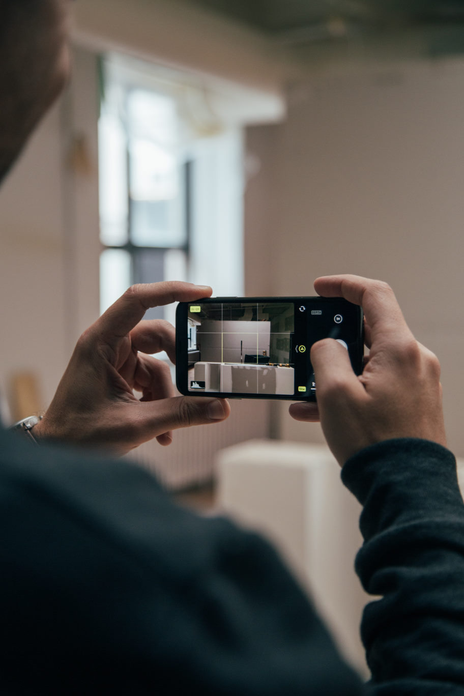 Image of modern smartphone taking a photo to be used for a home inspection.